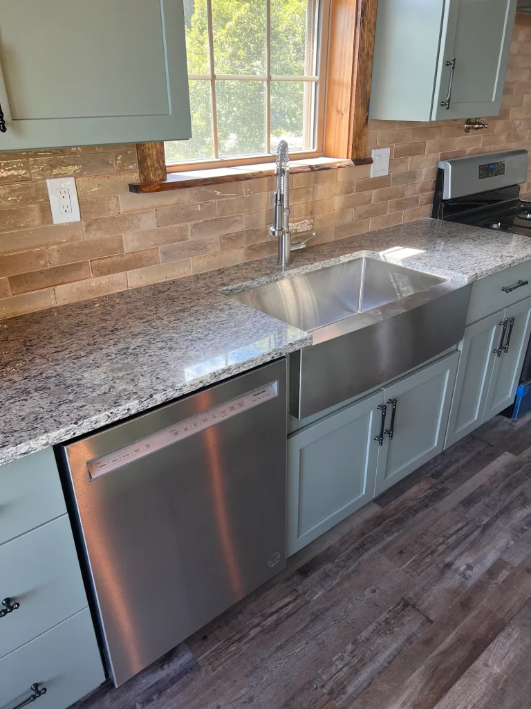 kitchen sink, counter, cabinets and dishwasher installed during home design