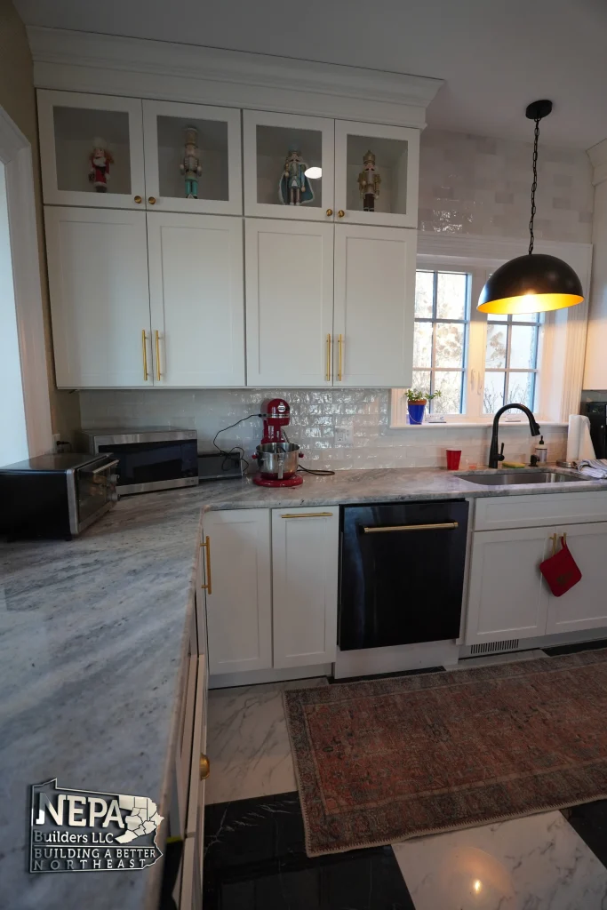 interior kitchen remodel with marble counter, backsplash and custom cabinetry