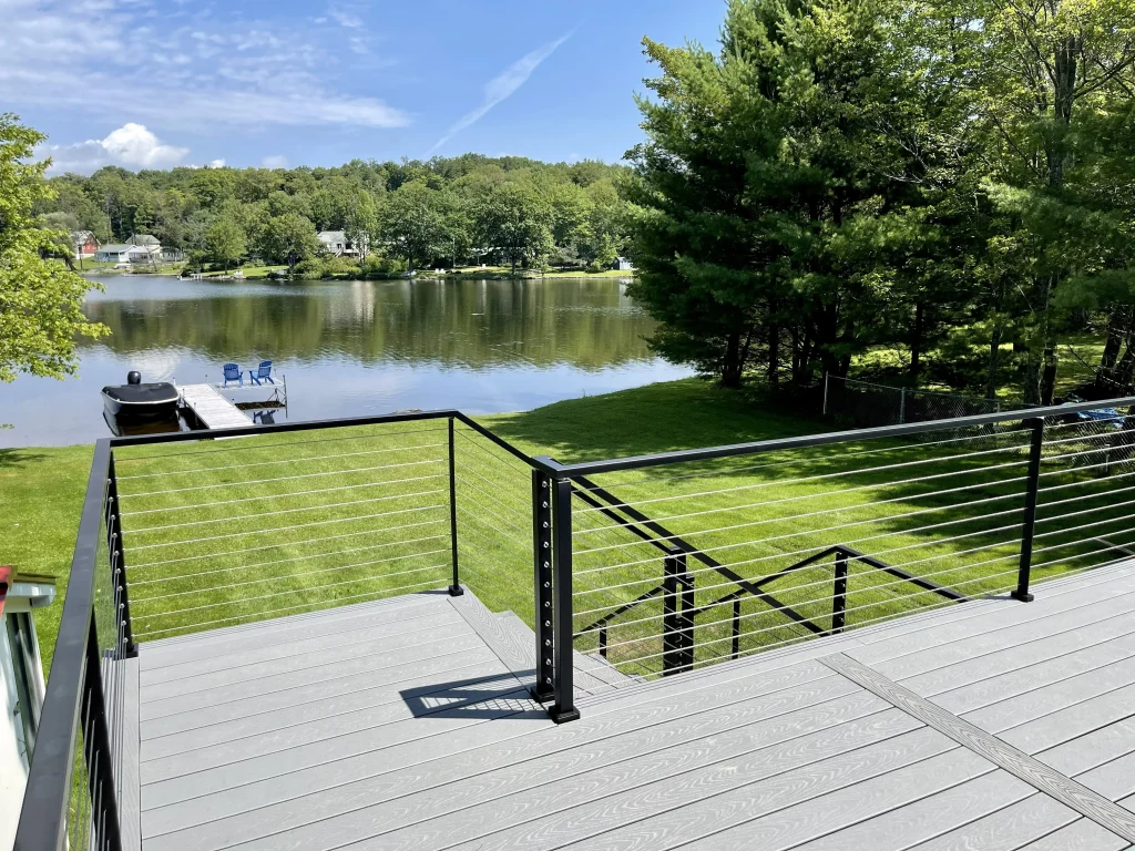 New deck with stairs and lakefront view -Uniondale