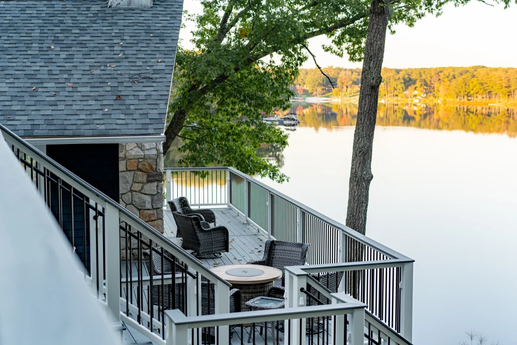 Original lakefront deck layout and patio furniture before a custom Trex deck and TexDeck transformation by NEPA builders in Pennsylvania.
