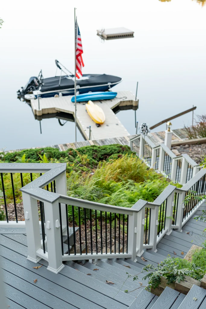 Custom Trex deck stairs and TexDeck railing leading down to a private boat dock on a Pennsylvania lake, crafted by NEPA builders.