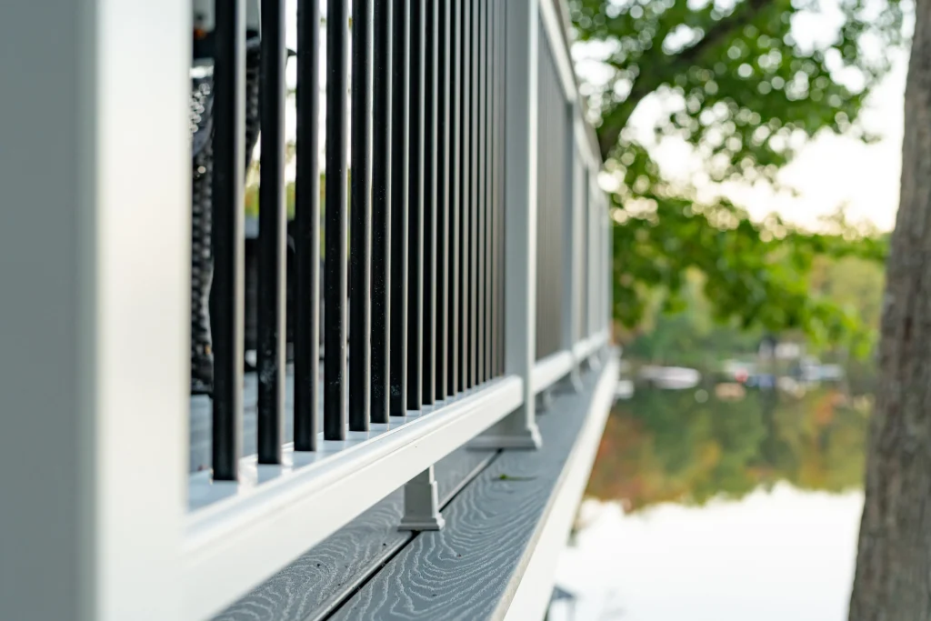 Close-up profile of the original deck railing and fascia board before a full Trex deck and TexDeck renovation by NEPA builders in Pennsylvania.