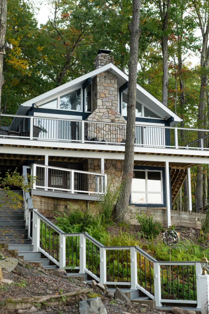 Vertical view of the original multi-level deck and unlit hillside stairs before a custom Trex deck and TexDeck remodel by NEPA builders.