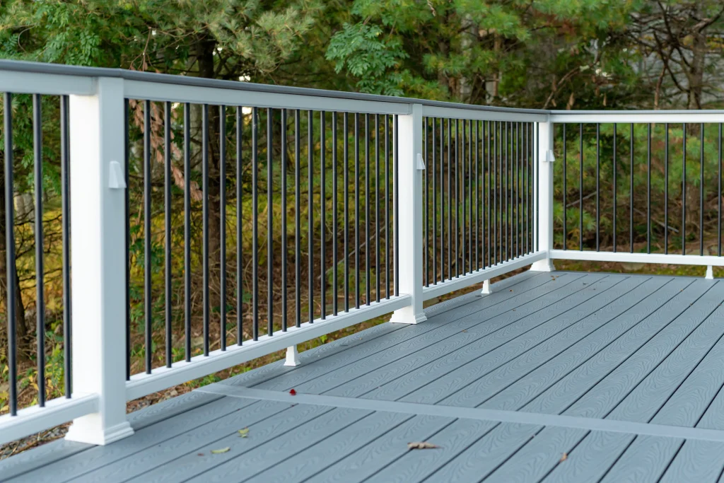 Original gray deck boards and white perimeter railing before a complete Trex deck and TexDeck rebuild by NEPA builders in Pennsylvania.