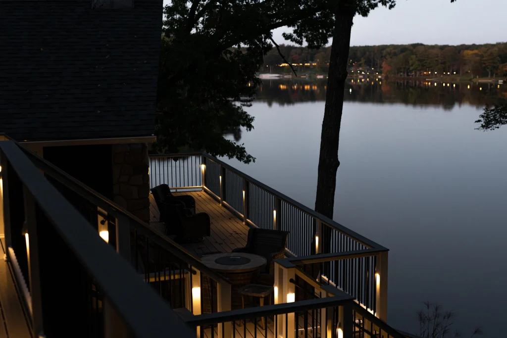 Finished low-maintenance Trex deck and TexDeck project overlooking Lake Teedyuskung at dusk, featuring custom lighting installed by NEPA builders in Pennsylvania.
