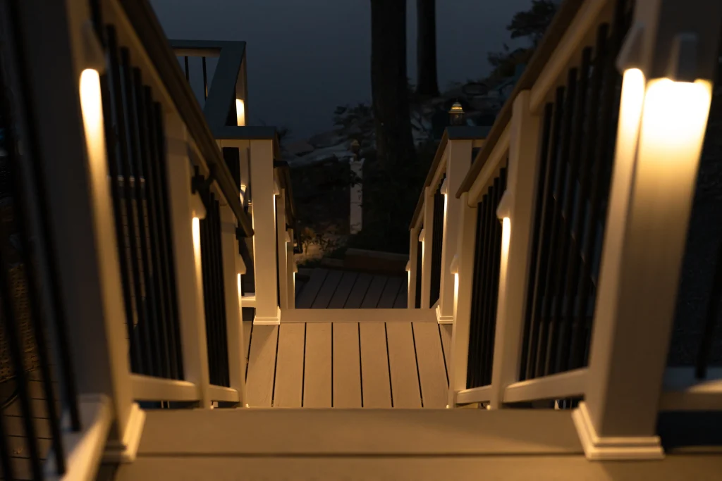lluminated Trex deck staircase with TexDeck post lighting creating a safe, lit path to the water, built by NEPA builders in Pennsylvania.