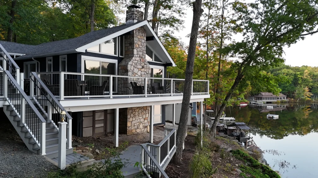 Custom lakefront Trex deck and TexDeck railing system installed on a multi-level home by NEPA builders.