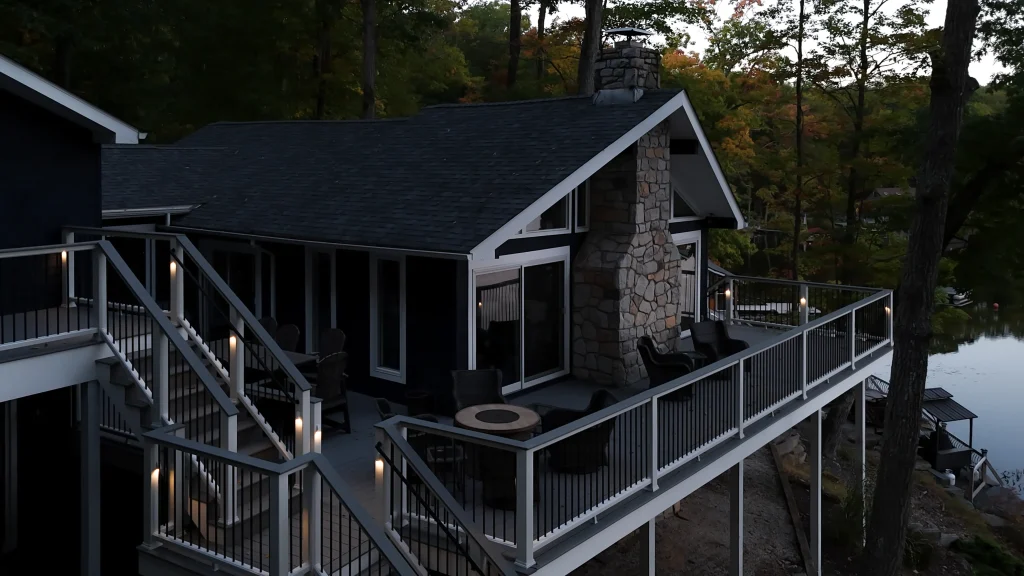 Finished multi-level Trex deck with integrated TexDeck railing lighting on a lakefront home, built by NEPA builders in Pennsylvania.
