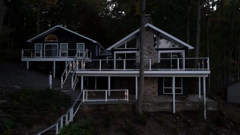 Front view of a completed multi-level Trex deck installation on a lakefront property at dusk, built by NEPA builders.