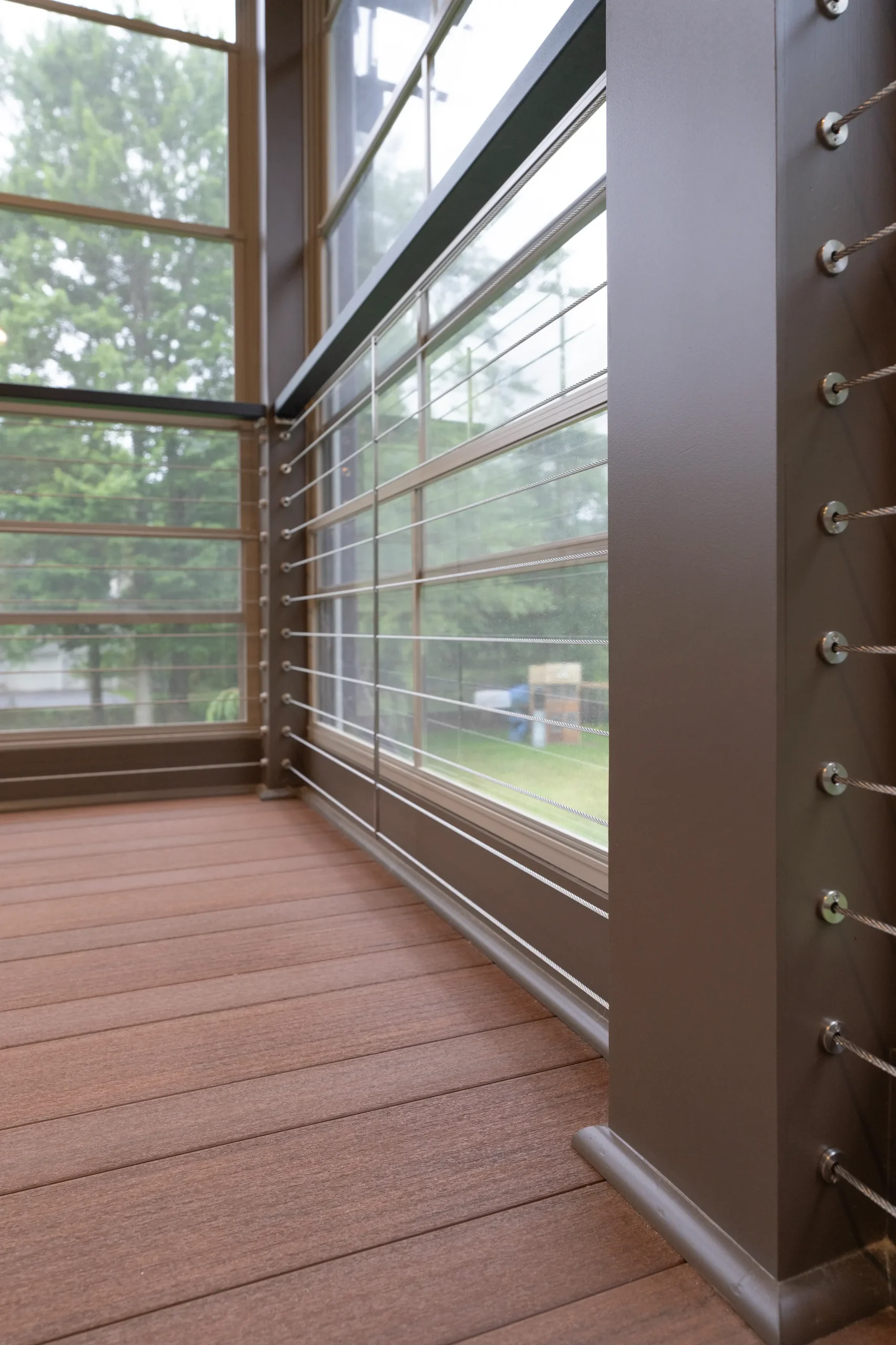 TimberTech Advanced PVC porch decking inside a custom Eze-Breeze three-season room with cable railing and expansive windows in Dalton, PA.